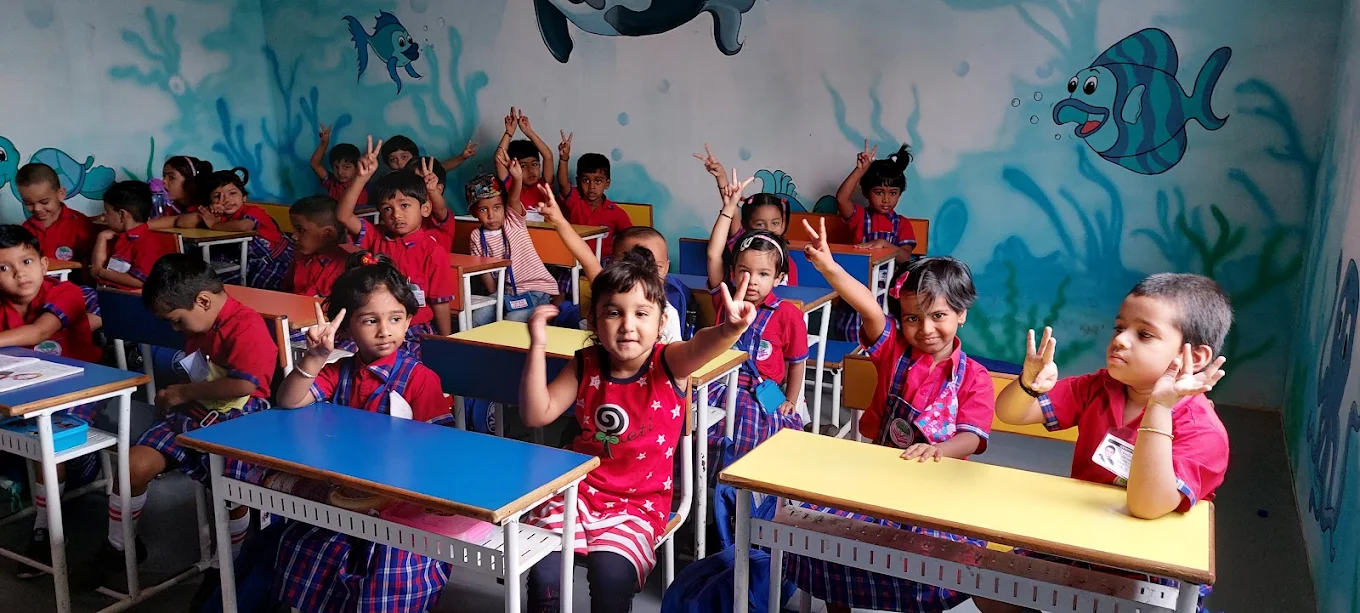 VH English Medium School students in classroom — happy pre-primary children in red and blue uniforms engaged in learning