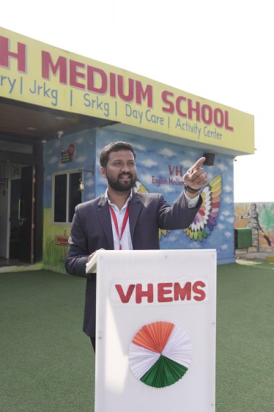 Akash Hingane, Principal of VH English Medium School Moshi, addressing students at the podium